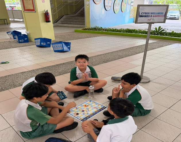 Students playing a cyber wellness board game
